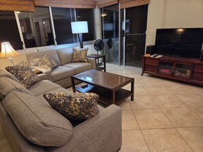 Living room with 50" TV.  Stereo, DVD player, Cable TV.  Games, puzzles, crayons