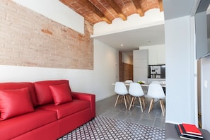 Comfortable living room with TV and dining area.