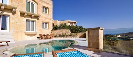 Outdoor deck area and pool with a glimpse of the views