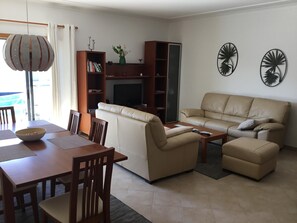 Living room with access to large balcony and pool view 