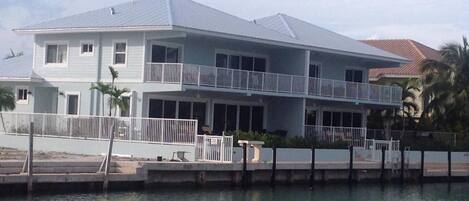 Rear of home facing canal, 50 foot dock each side, 100 feet wid if you rent both