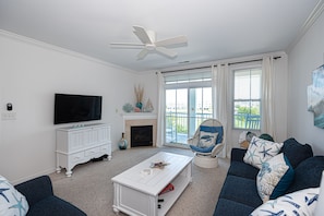 Family room area w gas fireplace & sliding door to balcony.  Check out the view!