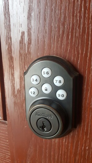 Front Door Keyless.  Enter code 
Host gives you to unlock
Press padlock to lock 