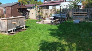 back yard with bar/counter on the left and fire pit to the right 