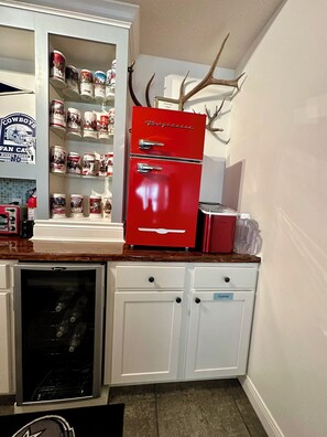 The bar comes complete with a Wine Fridge, Mini Fridge/Freezer and Ice Maker.