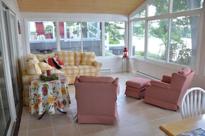 Sunroom with comfortable couch and two chairs with footstools & table w/4chairs