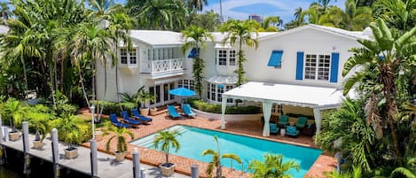 Gorgeous tropical  resort like pool area has plenty of sun and awning for shade