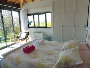 Front bedroom with view over pool, gardens and mountains.