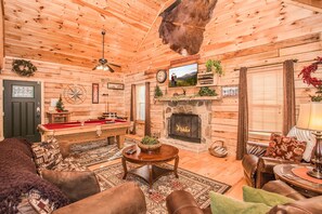 Spacious living room with a real-wood burning fireplace and flat