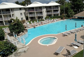 Largest swimming pool on 7 Mile Beach. View of hot tub and pool from our balcony