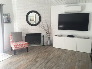 Modern, clean, living room with AC/Heat, 65" TV,  DVD, Remote fireplace
