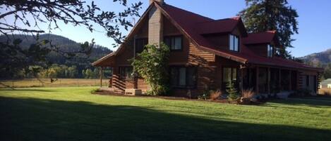 Side yard and south side view of the log home.