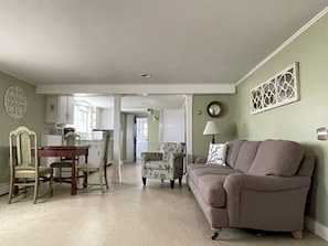 Full length view of living room, dining and kitchen area.