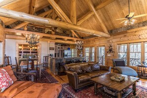 Living room with wood burning fireplace, TV and cozy furniture