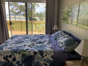 Main bedroom with sliding doors opening onto the large deck. 