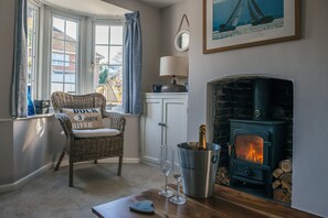 Woodburner & large sofa to cosy up on. There's TV & wifi or a good book to read