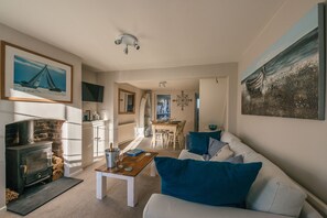 Lounge opens into dining area to give spacious feel. Comfy sofa & woodburner 
