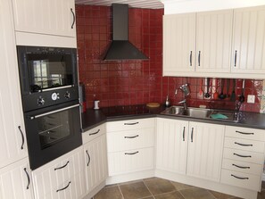 Kitchen with refrigerator and freezer. Basic stuff such as coffe, spices . . . 