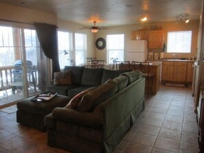 Living room with custom sectional and newly tiled floors