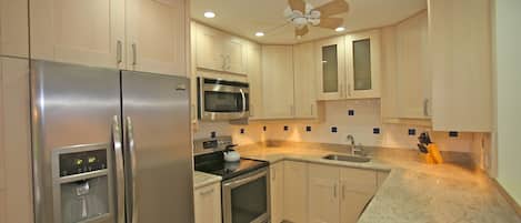 Kitchen - stainless steel appliances, granite counter tops, ceiling fan
