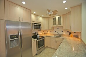 Kitchen - stainless steel appliances, granite counter tops, ceiling fan