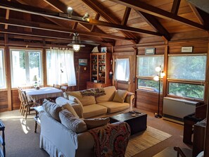 Living area looking to the dining area with redwood ceiling.