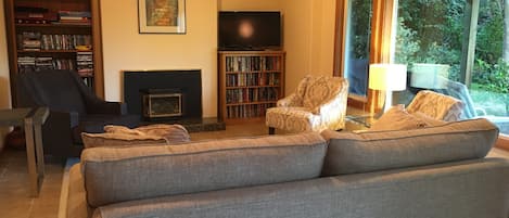 Cozy, open seating area in living room for reading, visiting & watching movies.