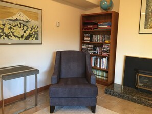 Reading area in living room with a wide selection of books, DVDs & board games.