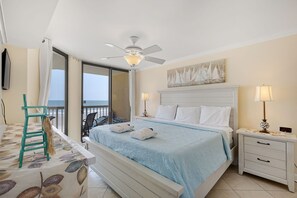 Main bedroom with ocean view and access to balcony