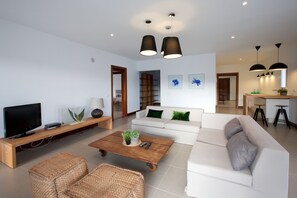 TV lounge room with view of kitchen bar