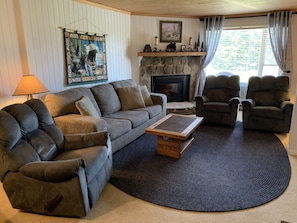 Living room w/ queen sleeper sofa, 3 rocker recliners & electric fireplace