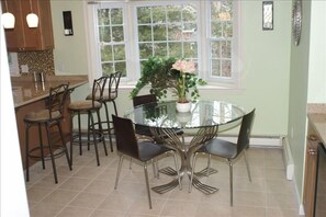 Dining area within the kitchen next to wet bar and wine cooler