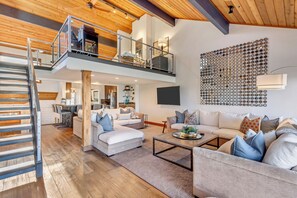 Large family room with 2 sectional sofas, cathedral ceiling, loft, fireplace.