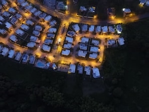 Aerial view of home next to basketball court, clubhouse, and swimming pool