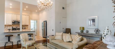 Elegant living room open to kitchen. Table opens up for dining.