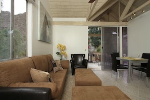 Living room with an expandable (up to 6)  table and Cathedral Wood Ceiling.