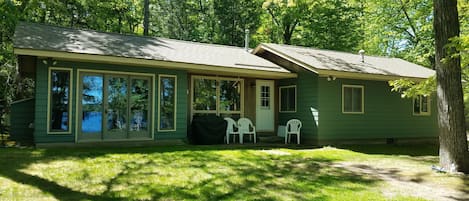 Big windows looking out at large private yard and lake. Gas grill provided