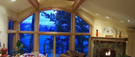 Great Room/Dining Room w/ wood burning fireplace, skylights & lake view balcony.