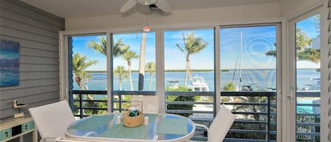 Enclosed glass lanai overlooking bay. 