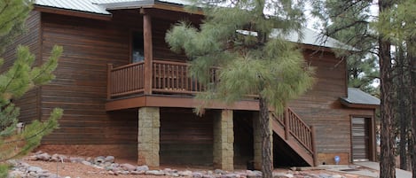 Front of the cabin with a covered deck to enjoy your coffee 