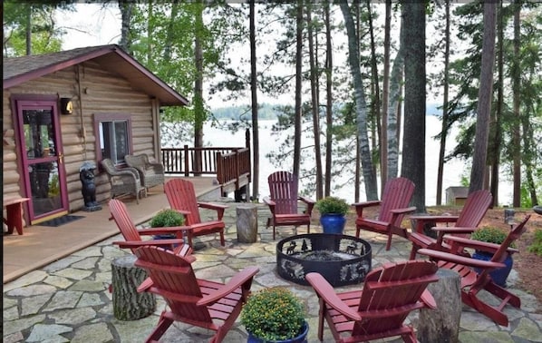 Fire Pit Over Looking Lake and Large Pines with Grilling Area