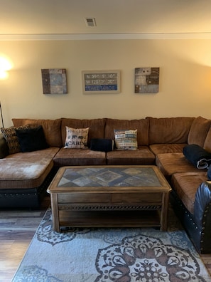 Large comfy sectional with lift up coffee table and ceiling fan