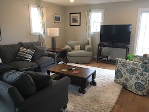 Brand new living room seating - large L couch, swivel chair and reading corner.