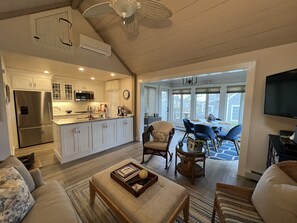 Open concept kitchen, living and dining space with cathedral ceiling.