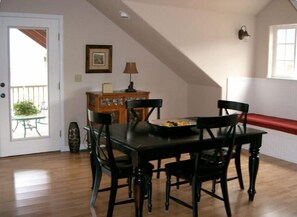 Dining area with deck in the background - table can sit as many as 6 