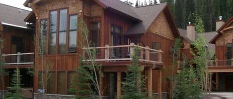 Front of condo w/ view of upper deck off great room and lower deck with hot tub