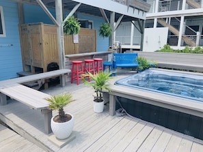 Hot tub deck with outside shower and foot rinse.