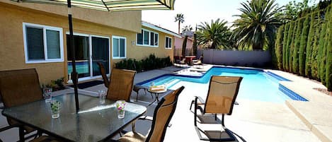 Large private pool and spa with BBQ, lounge chairs, patio table and gas fire pit