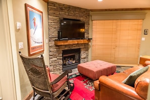 Living room area with TV and gas fireplace