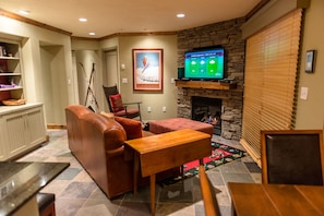 Living room area with gas fireplace, TV, and DVD